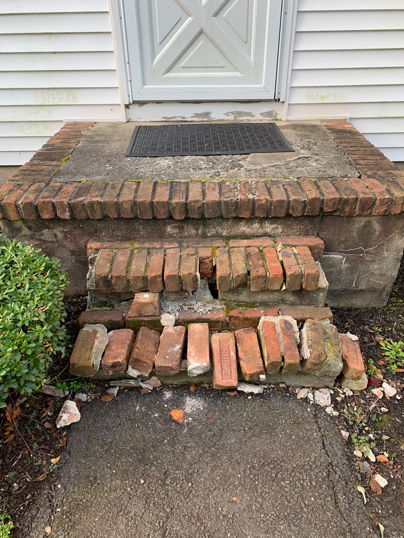Deteriorated brick entry steps before repair